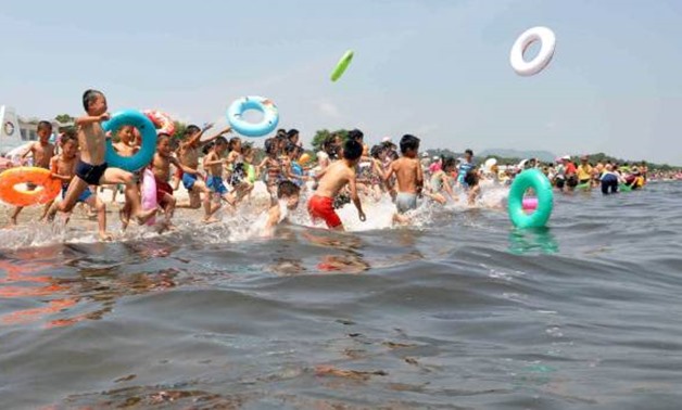 Schoolchildren play in the water at Songdowon International Children's Camp in Wonsan City - REUTERS