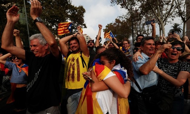 People celebrate after the Catalan regional parliament declares the independence from Spain in Barcelona - REUTERS