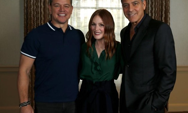 Director George Clooney (R) and cast members Matt Damon and Julianne Moore pose for a portrait while promoting the movie "Suburbicon" in Los Angeles, California, U.S., October 22, 2017. Picture taken October 22, 2017. REUTERS/Mario Anzuoni