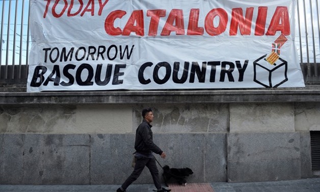 A man walks past a banner during a march organized by pro-Basque independence organization Gure Esku Dago (In Our Hands) in favor of a planned referendum on the independence of Catalonia, in Bilbao, Spain, Reuters