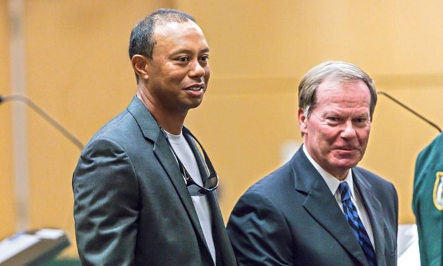 Golfer Tiger Woods leaves Palm Beach County court with his defense attorney, Douglas Duncan, after he pleaded guilty to a charge of reckless driving in connection with his May arrest for driving under the influence, in Palm Beach, Florida, U.S., Friday, O