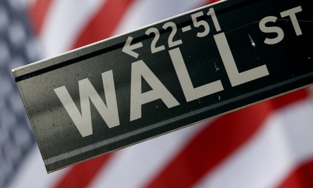 A street sign is seen in front of the New York Stock Exchange on Wall Street in New York, February 10, 2009. REUTERS/Eric Thayer (UNITED STATES)