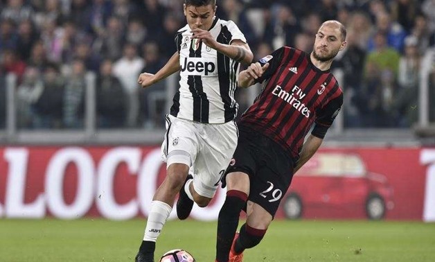 Juventus' Paulo Dybala in action against AC Milan's Gabriel Paletta. REUTERS/Giorgio Perottino