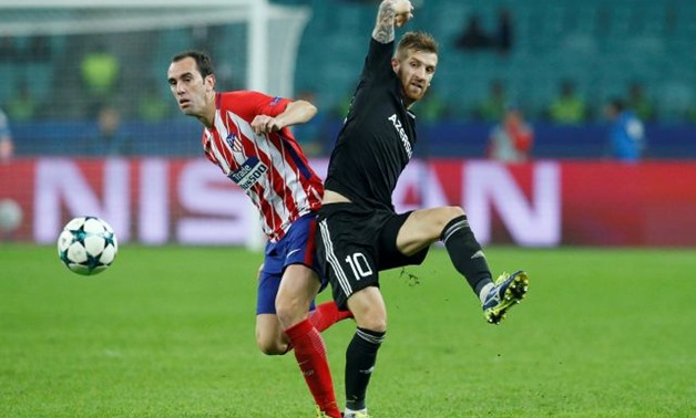Atletico Madrid's Diego Godin in action with Qarabag’s Pedro Henrique - REUTERS
