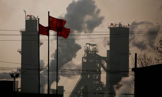Chinese national flags are flying near a steel factory in Wu'an, Hebei province, China, February 23, 2017. REUTERS/Thomas Peter/File Photo