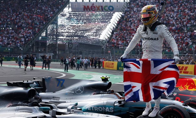 Mercedes' Lewis Hamilton celebrates after winning the World Championship –  Press image courtesy Reuters 