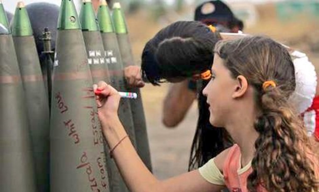 Photo posted by Lebanese Twitter users responding to Hashtag Tel Aviv Loves Beirut showing Israeli children ‎signing missiles before firing them on Lebanon in 2014 - Twitter October 29‎