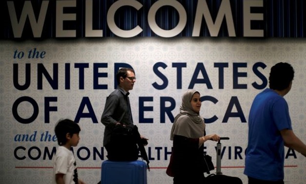 nternational passengers arrive at Washington Dulles International Airport in Dulles - REUTERS
