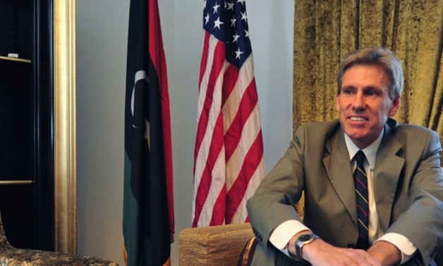 Christopher Stevens, the U.S. ambassador to Libya, smiles at his home in Tripoli June 28, 2012. Stevens and three embassy staff were killed late on September 11, 2012, as they rushed away from a consulate building in Benghazi, stormed by al Qaeda-linked g