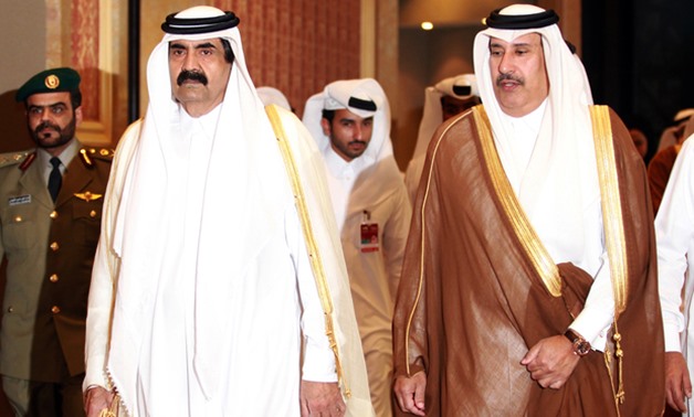 Former Emir of Qatar Sheikh Hamad bin Khalifa Al-Thani (L) and former Qatari Prime Minister and Foreign Minister Sheik Hamad bin Jassem Al-Thani (R) at the opening of the Doha Forum (AFP)