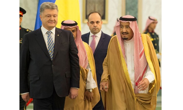 Saudi Arabia's King Salman bin Abdulaziz Al Saud walks with Ukrainian President Petro Poroshenko during a reception ceremony in Riyadh - REUTERS