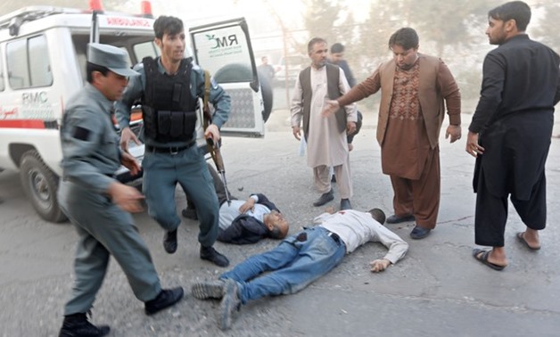 Policemen stand near casualties after a blast in Kabul - REUTERS