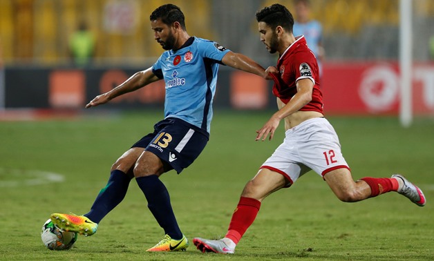 Wydad's Youssef Rabeh in action with Al Ahly's Walid Azarou - REUTERS