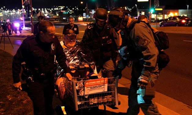 Patrick Carnes is evacuated in a Walmart cart by SWAT medics from the scene of a shooting at a Walmart where Carnes was shopping in Thornton - REUTERS
