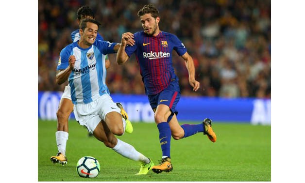 Barcelona’s Sergi Roberto in action with Malaga's Luis Hernandez - REUTERS