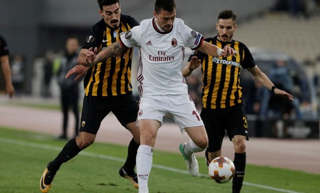 AEK Athens' Lazaros Christodoulopoulos and Helder Lopes in action with AC Milan's Alessio Romagnoli -
 REUTERS/Alkis Konstantinidis
