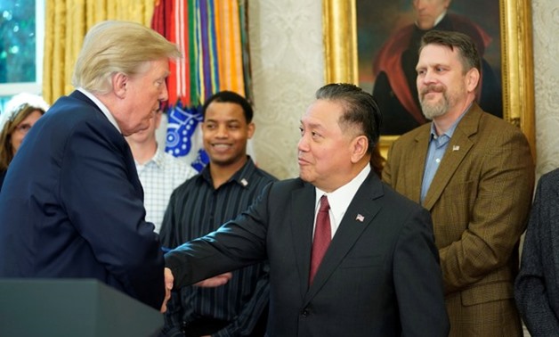 U.S. President Donald Trump shakes hands with Hock E. Tan, CEO of Broadcom as Trump delivered remarks about the situation of the jobs market in the Oval Office of the White House in Washington - REUTERS