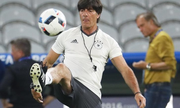 Germany coach Joachim Loew controls the ball during training. REUTERS/Pascal Rossignol