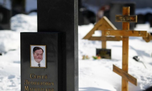 FILE PHOTO: A picture of lawyer Sergei Magnitsky is seen on his grave in the Preobrazhensky cemetery in Moscow March 11, 2013. REUTERS/Mikhail Voskresensky
