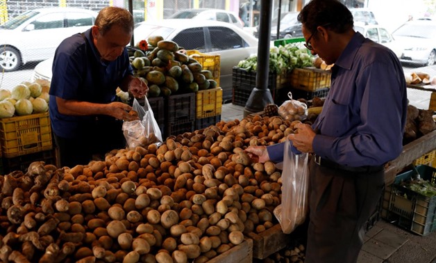 People select potatoes at a street market in Caracas, Venezuela November 3, 2017. REUTERS/Marco Bello