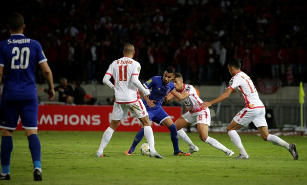 Al Ahly's Mo’men Zakaria in action with Wydad's Ismail El Haddad REUTERS/Youssef Boudlal