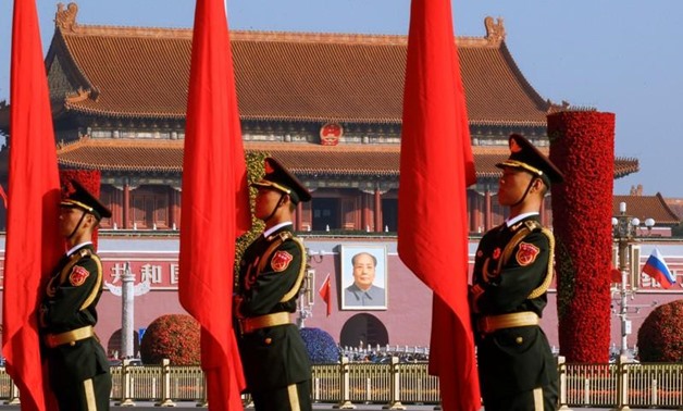Chinese honour guards stand to attention near a portrait of China's late Chairman Mao Zedong before a welcoming ceremony for Russian Prime Minister Dmitry Medvedev (not pictured) at the Great Hall of the People in Beijing - REUTERS/Thomas Peter