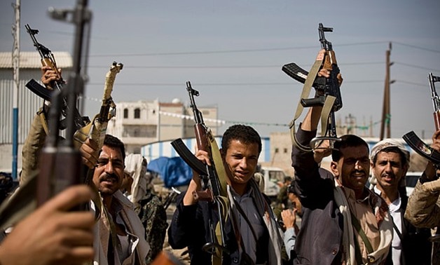 Houthi Shiite Yemeni hold their weapons during clashes near the presidential palace in Sanaa, Yemen - AFP