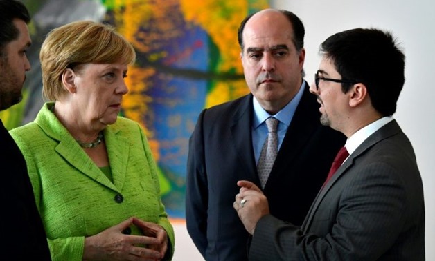 Freddy Guevara (R), seen here meeting German Chancellor Angela Merkel in September, requested Chile's protection after Venezuela's high court announced he would be prosecuted on charges punishable by a decade in prison