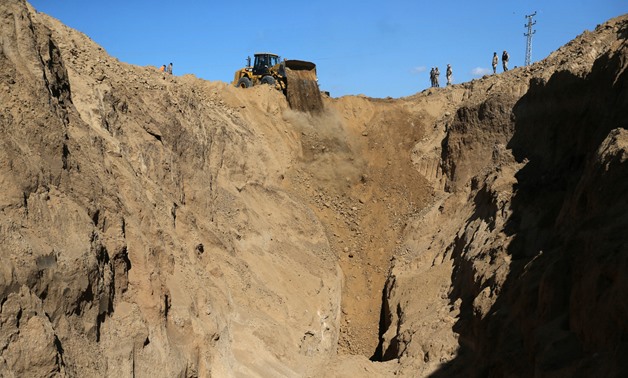 A bulldozer operates while searching for missing or dead militants after Israel blew up a cross-border tunnel, in Khan Younis in the southern Gaza Strip November 3, 2017. Picture taken November 3, 2017. REUTERS/Ibraheem Abu Mustafa