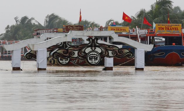 A bridge is seen on the overflowing Thu Bon river in UNESCO heritage ancient town of Hoi An after typhoon Damrey hits Vietnam November 6, 2017. REUTERS/Kham
