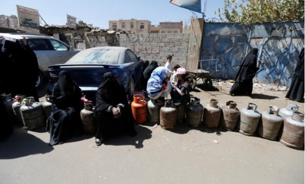 Women sit on cooking gas cylinders lined up outside a gas station amid supply shortage in Sanaa, Yemen November 7, 2017 - REUTERS/Khaled Abdullah