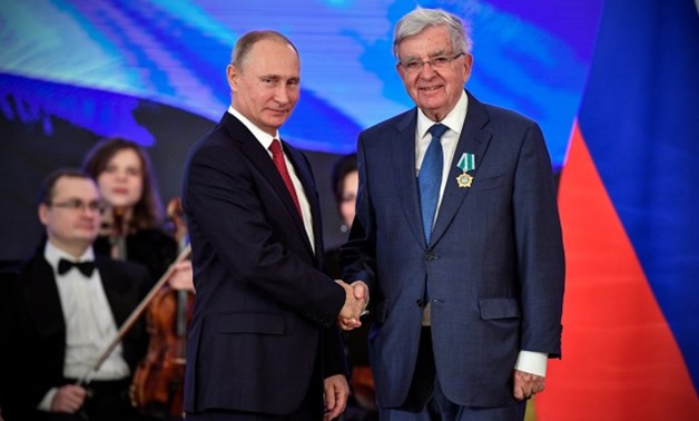 Russia's President Vladimir Putin decorates Special Envoy of the France's Government for Economic Relations with Russia Jean-Pierre Chevenement with the People's Friendship order during a reception on the National Unity Day at the Kremlin in Moscow, Russi