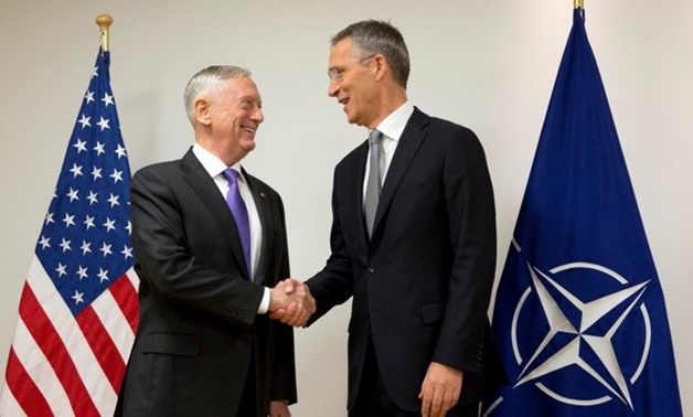 U.S. Secretary for Defense Mattis shakes hands with NATO Secretary General Stoltenberg prior to a meeting at NATO headquarters in Brussels - REUTERS