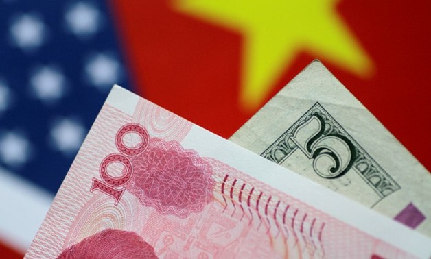 U.S. Dollar and China Yuan notes are seen in this picture illustration June 2, 2017 - REUTERS/Thomas White/Illustration/File Photo