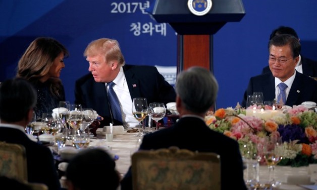 U.S. President Donald Trump and First Lady Melania talk during a state dinner hosted by South Korea's President Moon Jae-in (R) in his honor at the Blue House in Seoul, South Korea November 7, 2017 - REUTERS/Jonathan Ernst TPX IMAGES OF THE DAY