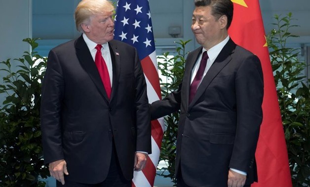 FILE PHOTO - U.S. President Donald Trump and Chinese President Xi Jinping (R) meet on the sidelines of the G20 Summit in Hamburg, Germany, July 8, 2017.
