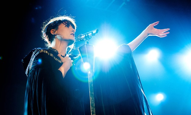 A look in depth at Florence + the machine's depiction of unrequited love through their song "Cosmic Love"- Florence Welch at a concert in May 2012 - Anaïs Chaine - Wikimedia commons