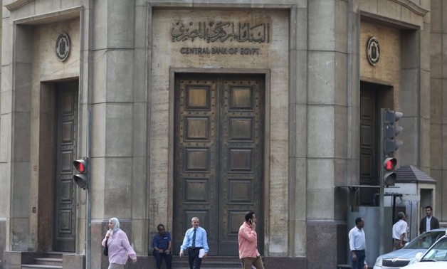 People walk in front of the Central Bank of Egypt's headquarters at downtown Cairo, Egypt - Reuters