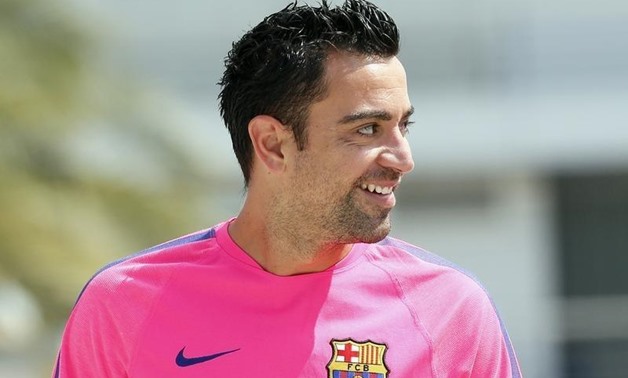 FC Barcelona's player Xavi Hernandez smiles before a news conference at Joan Gamper training camp, near Barcelona August 5, 2014 - REUTERS/Albert Gea
