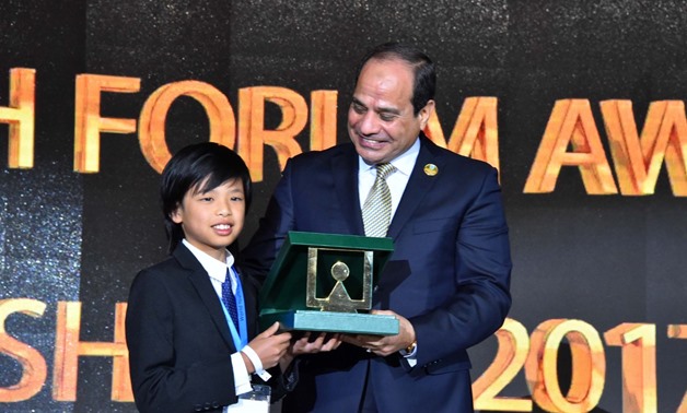 President Sisi honors Yuma Soerianto, youngest programmer who designed four applications, one dedicated to helping families unable to afford the food to find a place to eat- press photo