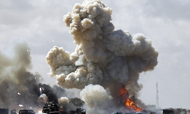 Full force: A huge explosion engulfs several cars with Gaddafi forces today as the full allied assault gets underway - Reuters