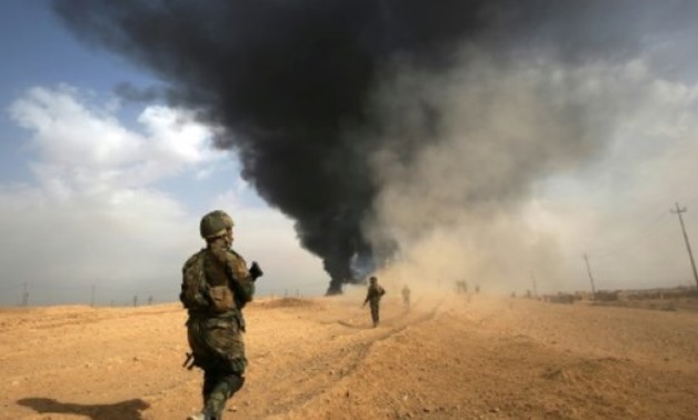 AFP/File | Iraqi forces advance towards the town of Al-Qaim near the Syrian border on November 3, 2017 as they battle the last remnants of the Islamic State group