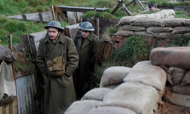 Actors Jake Morgan and Sam Ducane pose for photographs at the launch of the 1918 Poppy Pledge in a re-creation of a First World War trench at Pollock House in Glasgow, Scotland November 10, 2017. REUTERS/Russell Cheyne