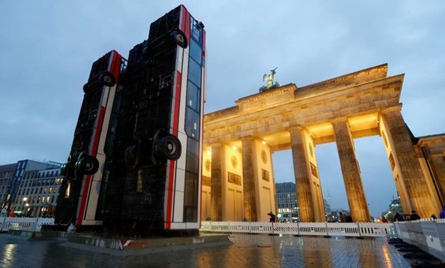 An installation "Monument" by German-Syrian artist Manaf Halbouni stands in front the Brandenburg Gate in Berlin, Germany, November 10, 2017. The installation, previously displayed in Dresden, displays three upended buses to mimic a defensive barricade er