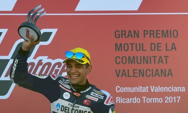 Del Conca Gresini Moto3 Spanish rider Jorge Martin celebrates on the podium after winning the Moto3 race of the Valencia Grand Prix at Ricardo Torto racetrack in Cheste, near Valencia on November 12, 2017
