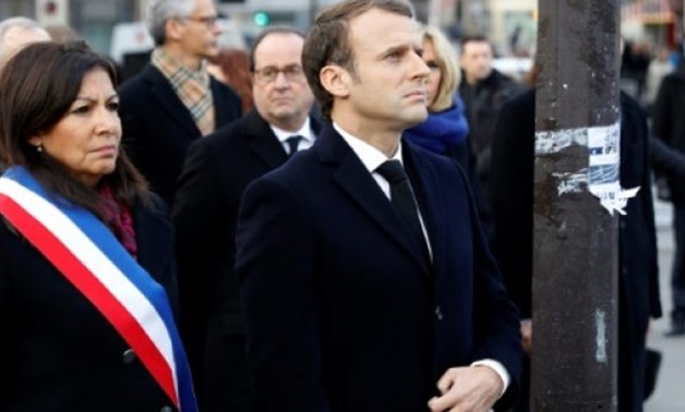 © POOL/AFP | President Emmanuel Macron, Paris mayor Anne Hidalgo and former president Francois Hollande pay tribute to the victims of the 2015 attacks