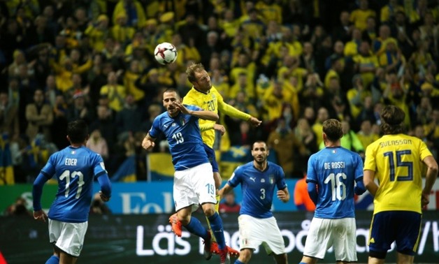 Sweden's Ola Toivonen (up-R) heads the ball over Italy's Leonardo Bonucci during their FIFA 2018 World Cup qualification first leg match, in Solna, Sweden, on November 10, 2017