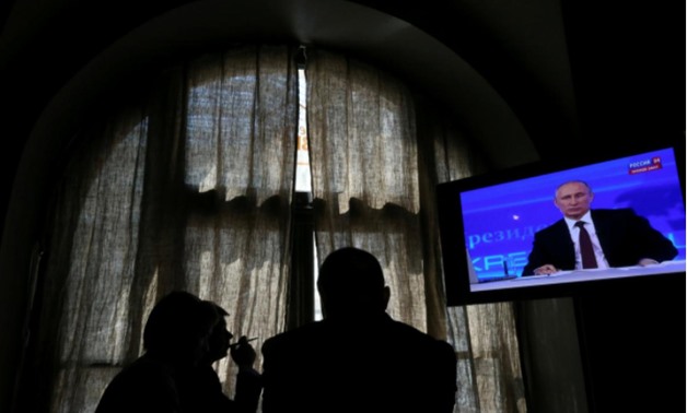 People look at a screen at a media centre during Russian President Vladimir Putin's live broadcast nationwide phone-in in Moscow, Russia April 17, 2014 -
 REUTERS/Sergei Karpukhin/File Photo