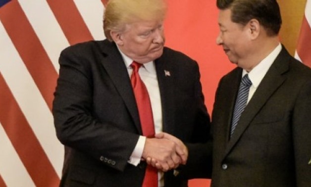 US President Donald Trump shakes hands with China's Xi Jinping during his visit to Beijing last week - AFP 