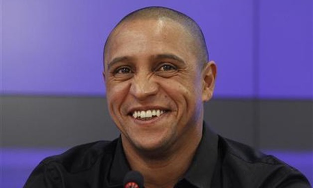 Anzhi Makhachkala team director Roberto Carlos laughs during a news conference in Moscow March 29, 2012. REUTERS/Sergei Karpukhin